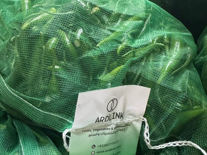 Green chillies in a mesh sack with an Ardlink tag